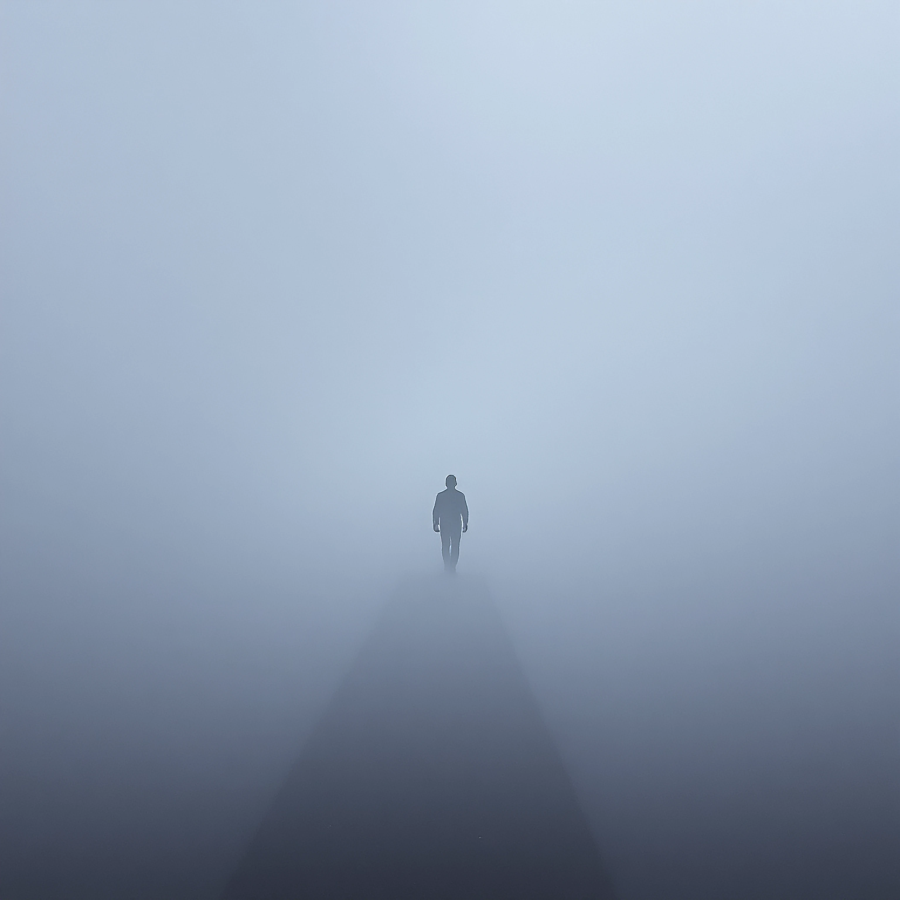A solitary figure wandering through thick Monday morning fog, translucent ghostly bodies floating weightlessly in the misty空間, ethereal forms suspende