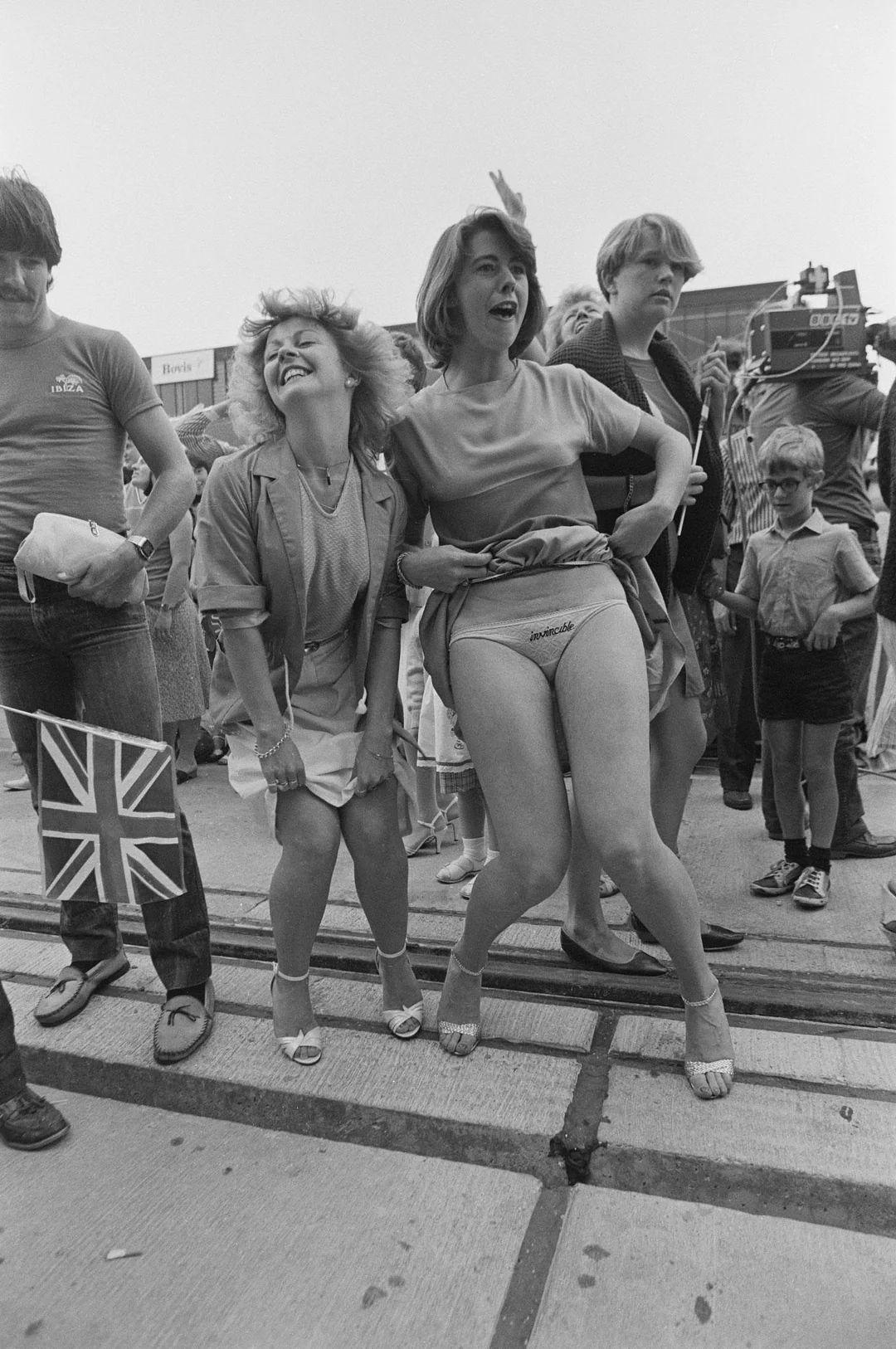 a young woman with the word 'Invincible' embroidered on her underwear welcomes HMS Invincible back f…