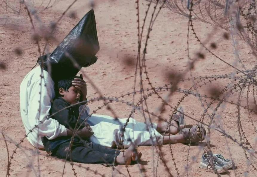 iraqi prisoner of war comforting his 4-year-old son in Najaf, Iraq March 31, 2003