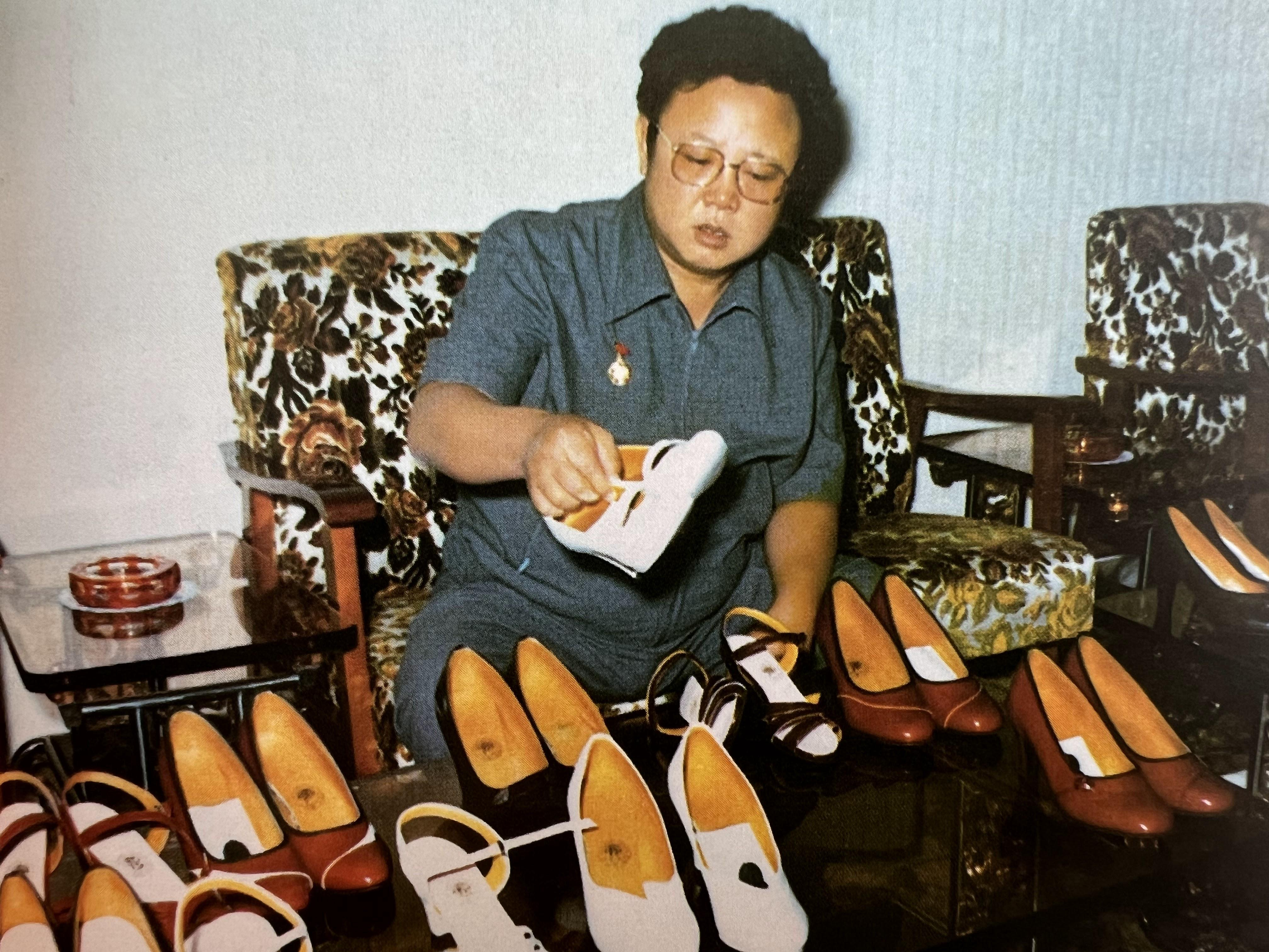 future leader of North korea Kim Jong il inspecting high heels, (Kim himself was known for wearing s…