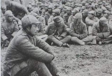 lieutenant General Huang Wei sat with his followers after being captured by Communist, December 15,…