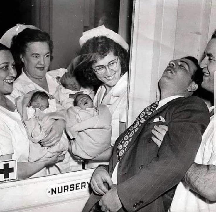 nurses show triplets to the father who pass out of emotion. Picture from 1946 in New York , when the…