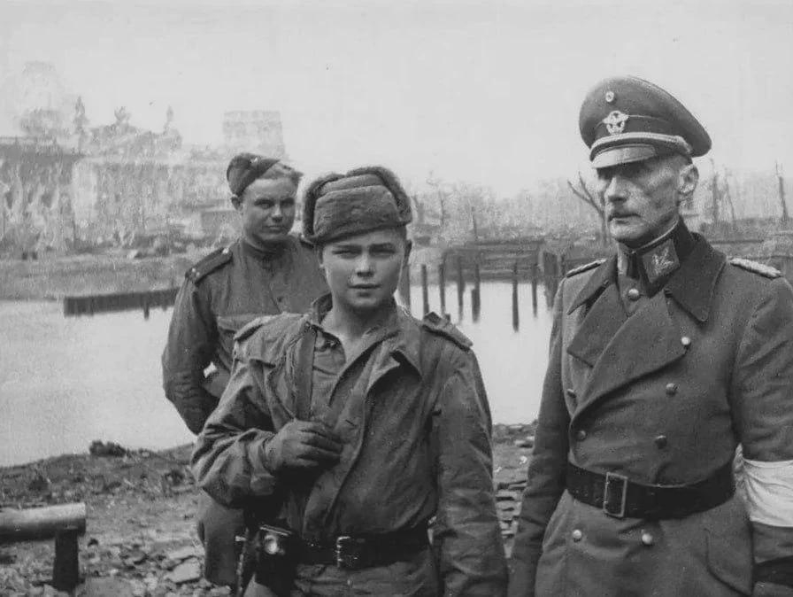 a German General and a young Soviet boy who took him prisoner, Berlin, 1945