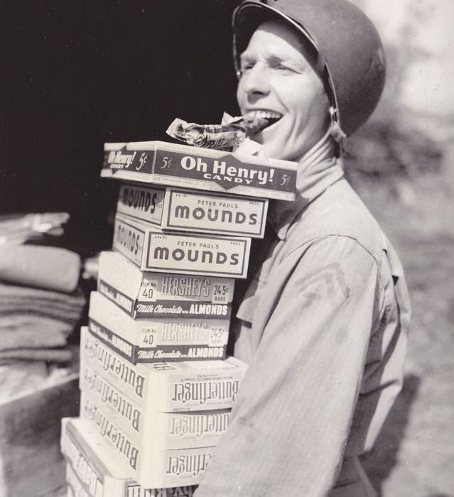 happy GI on his way to pass out candy rations to his buddies, ca 1944
