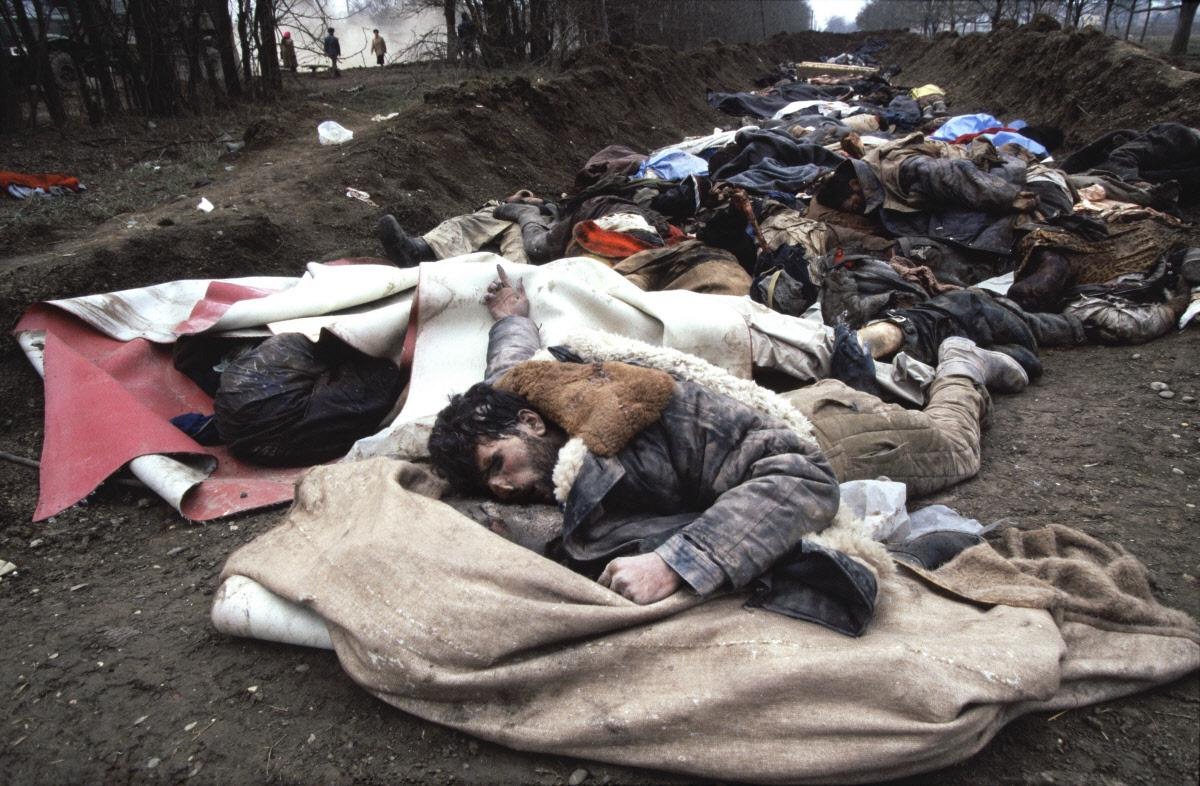 mass graves at the edge of Grozny where men deposit the hundreds of unidentified bodies found in the…
