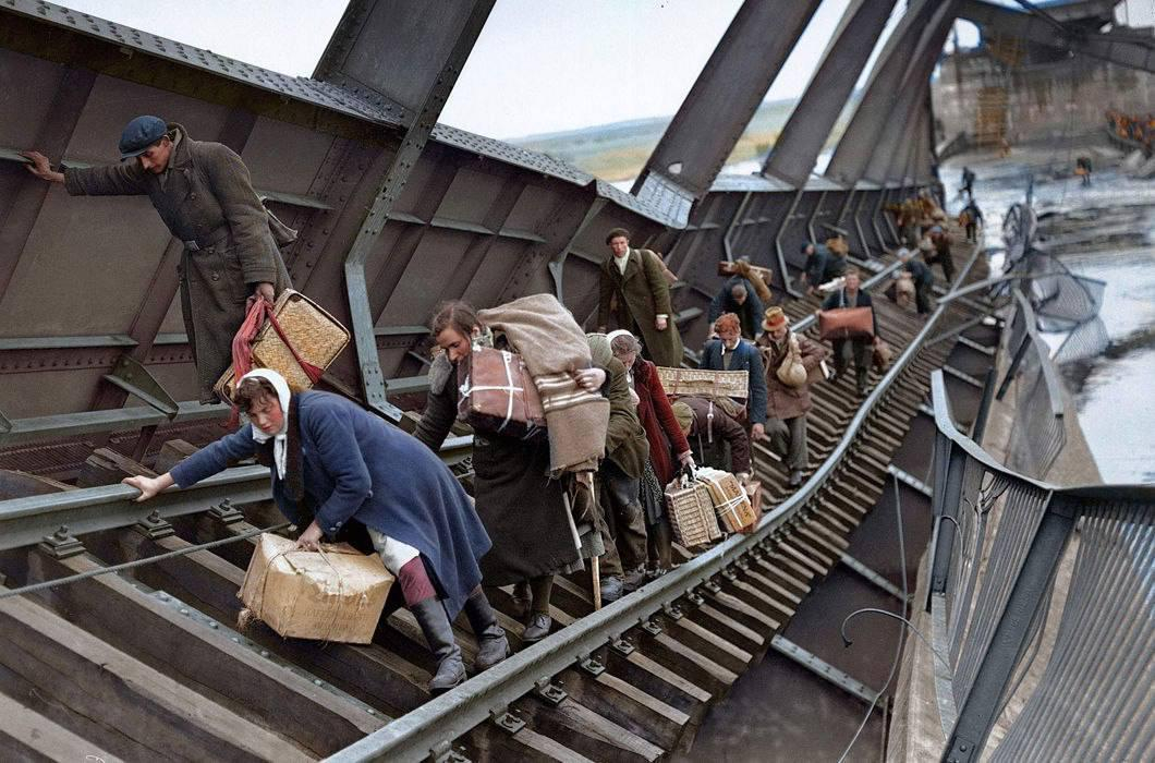 german refugees cross a destroyed bridge. Elbe River, Germany, May 1, 1945