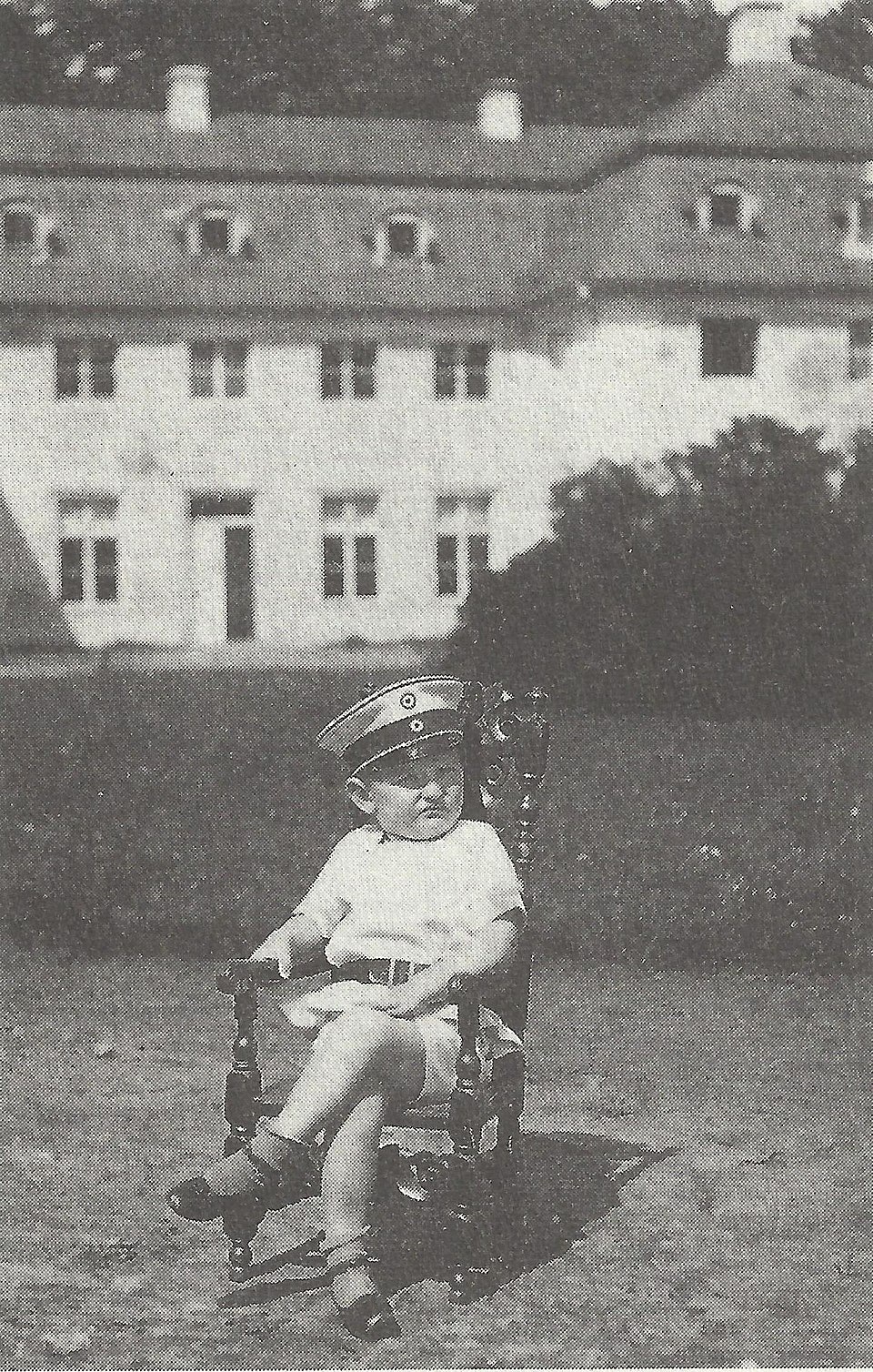 prussian nobleman's son Alexander zu Dohna-Schlobitten, 7, sits in a chair at his family's estate (G…