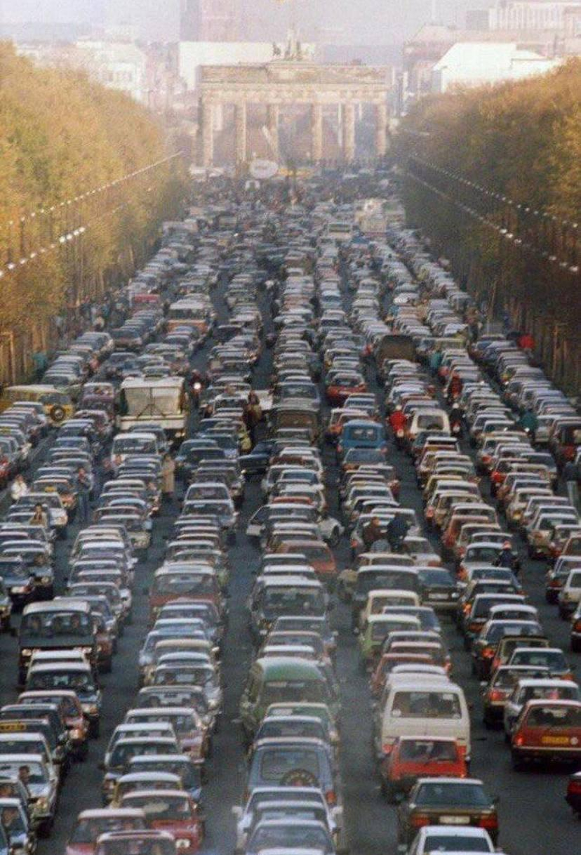 a traffic jam at the Brandenburg Gate between East and West Berlin on the first Saturday after the f…
